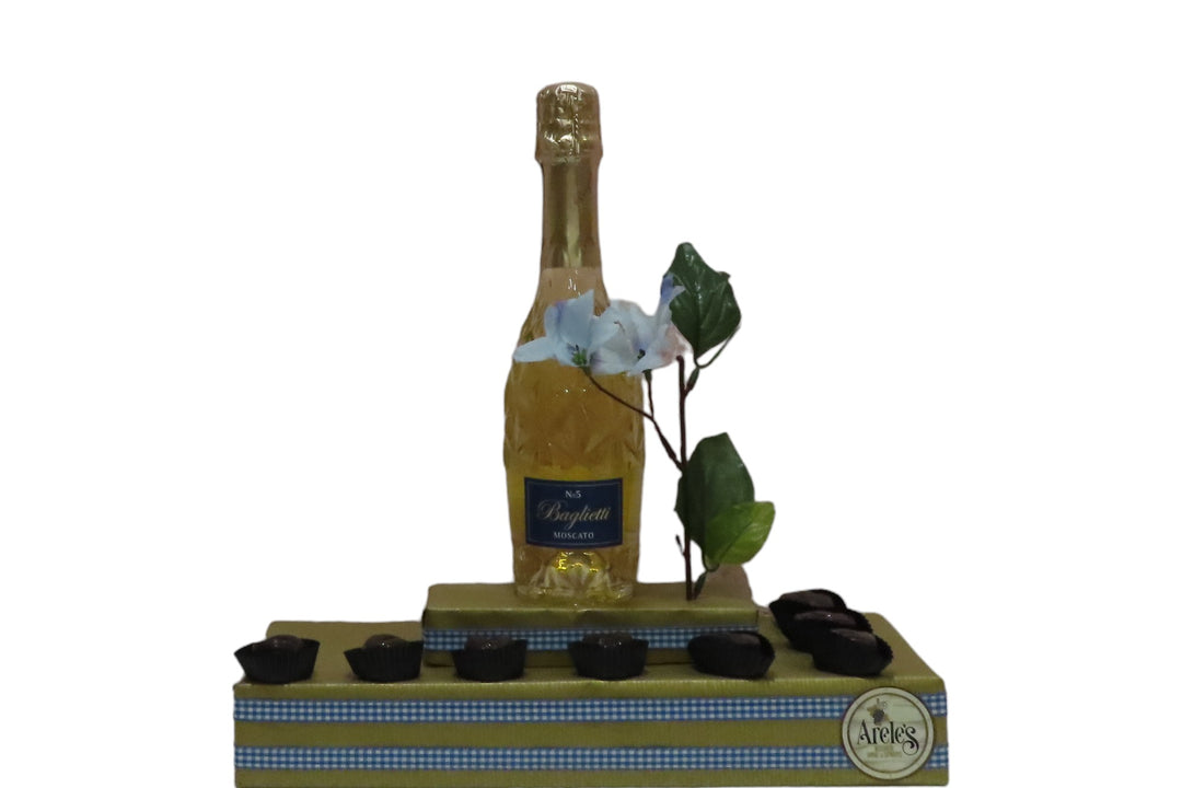 White baglietti champagne bottle along with chocolates for kosher wine gift.