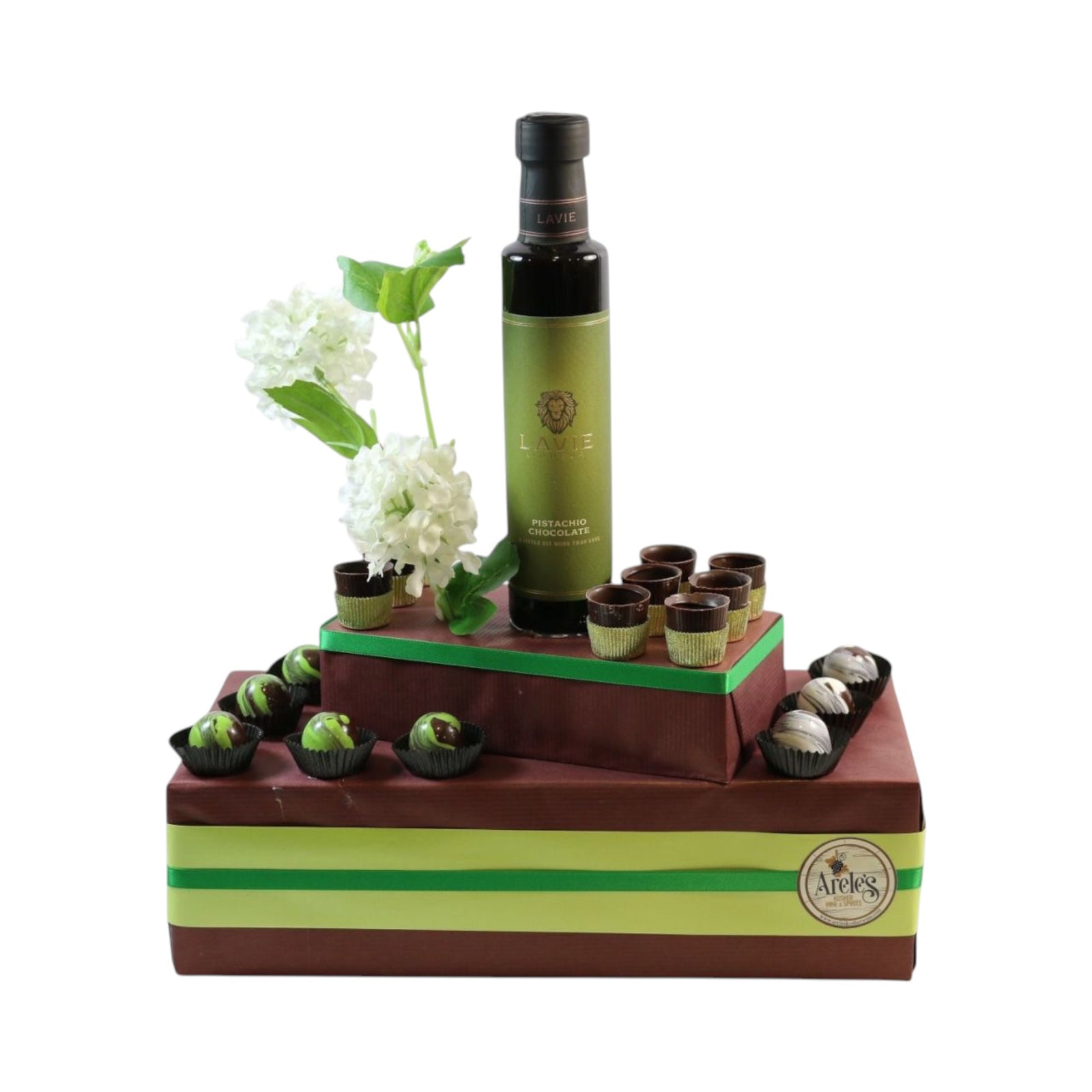 Premium gift arrangement with pistachio chocolate liqueur bottle, small pistachio chocolates, and decorative elements. Dubai chocolate arrangement. 